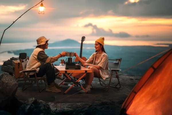 Asian couple sweet in tent inside on they camping trip, traveller relax and sleep togather in out door and camping trip
