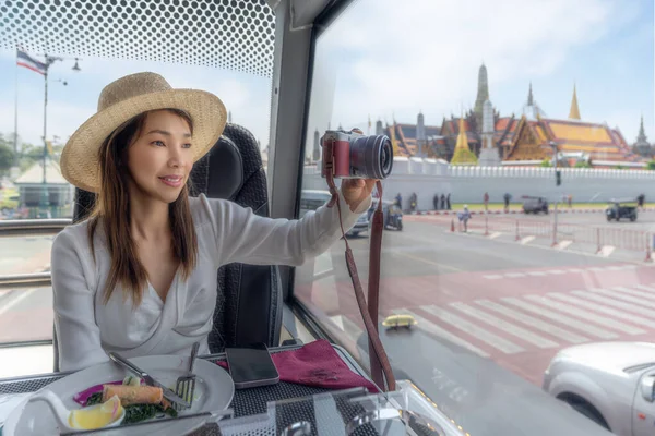 亚洲女游客在往返于城市之旅和泰国王宫酒店之间的餐馆巴士上吃午饭 — 图库照片
