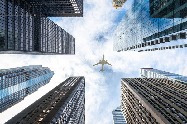 Airplane fly over roof top of building and city of Chicago city, USA