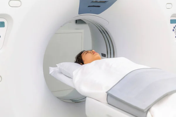 Asian woman patient check up her body by ct scan machine, ct scanner for examination health checkup in hospital