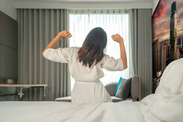 Asian woman traveler sleep and wake up in hotel room in Bangkok city, Bangkok, Thailand