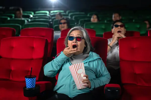 Old woman shocked with scary movie in theater and enjoy her holiday with 3d glass