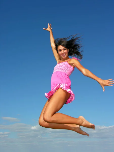 young attractive woman flying in the sky in sunny day