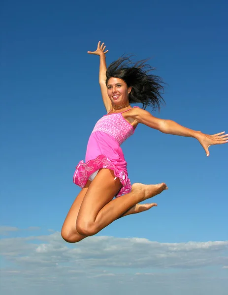 young attractive woman flying in the sky in sunny day