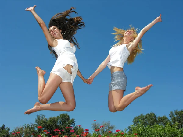 Two Cheerful Girlfriends Jumping Outdoors Sunny Day — Stock Photo, Image