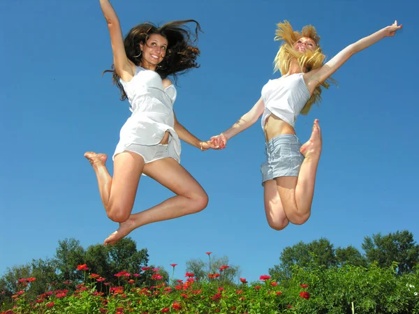 Two Cheerful Girlfriends Jumping Outdoors Sunny Day — Stock Photo, Image