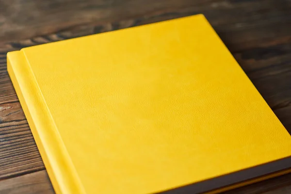 Photo Album Bright Yellow Hardcover Isolated Brown Wooden Background Perspective — Stock Photo, Image