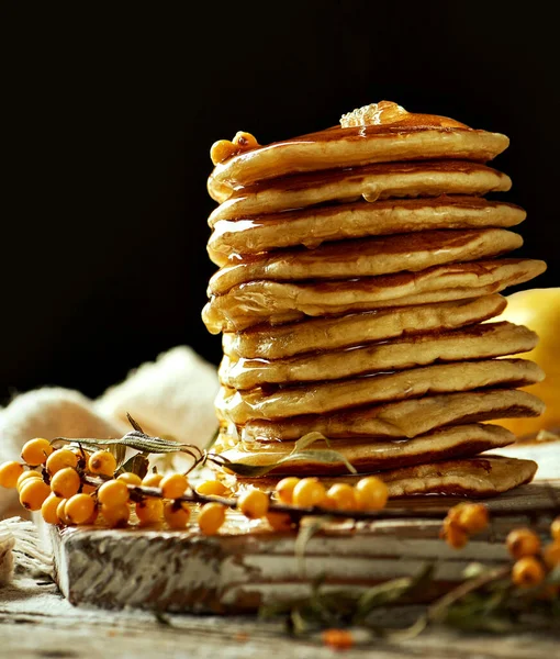 Fluffy Pancakes Poured Honey Light Wooden Board Sprig Sea Buckthorn — Stock Photo, Image
