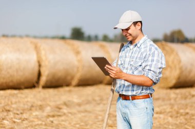 Smiling farmer using a tablet