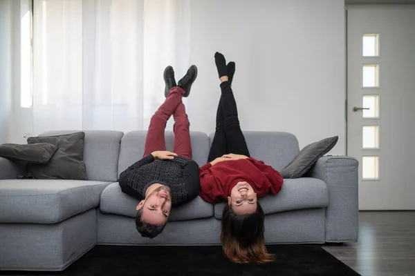 stock image Couple upside down on the couch in their apartment