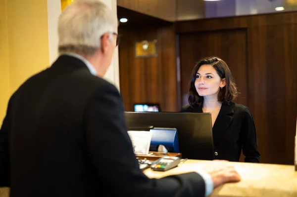 Customer checking in at a hotel reception