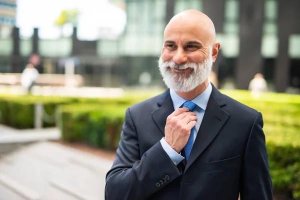 Smiling Bald Businessman Adjusting His Necktie While Walking City — Stock Photo, Image