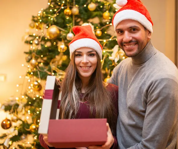 Young Couple Opening Christmas Gift — Stock Photo, Image