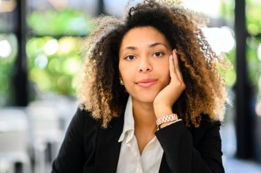 Confident young afro american female manager outdoor smiling in a relaxed mood