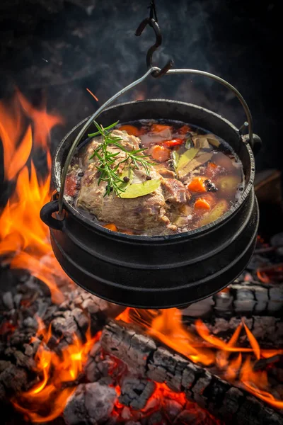 Stock image Delicious and hot hunter's stew made of meat and vegetables. Hunting stew on the fire while hunting.