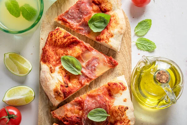 Delicious and hot pizza served with lemonade. Poster for Restaurant. Pizza with salami and cheese.