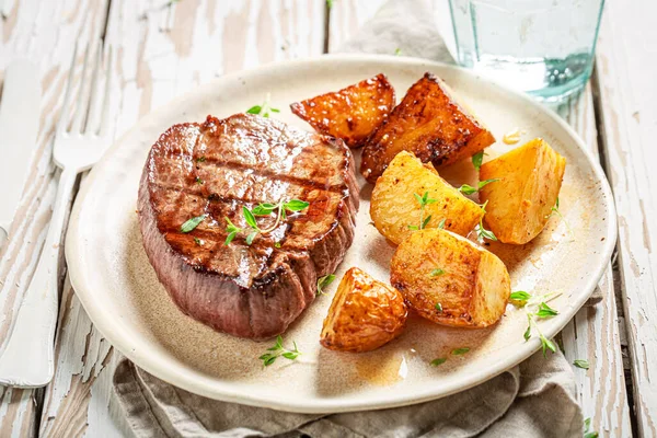 Tasty Steak Roasted Potatoes Herbs Served Water Table — Stock Photo, Image