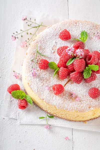 Homemade cheesecake decorated with raspberries and mint. Raspberry cheesecake.