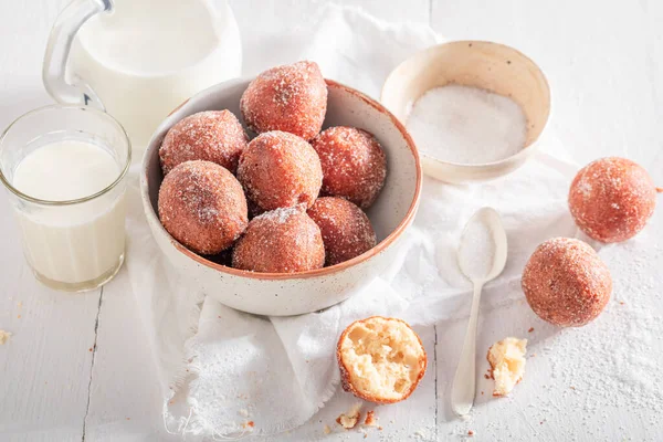 stock image Delicious mini doughnuts with caster sugar and milk. Doughnuts served with milk and sugar.