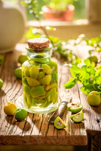 stock image Homemade and tasty quince tincture made of alcohol and fruits in garden