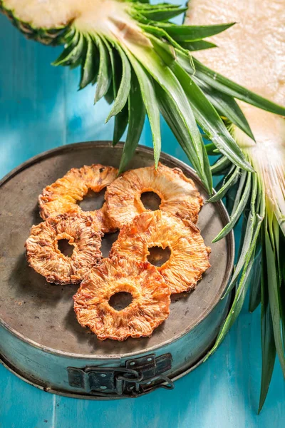 Tasty and homemade sun dried pineapple as a snack. Dried fruits in the sun in the garden.