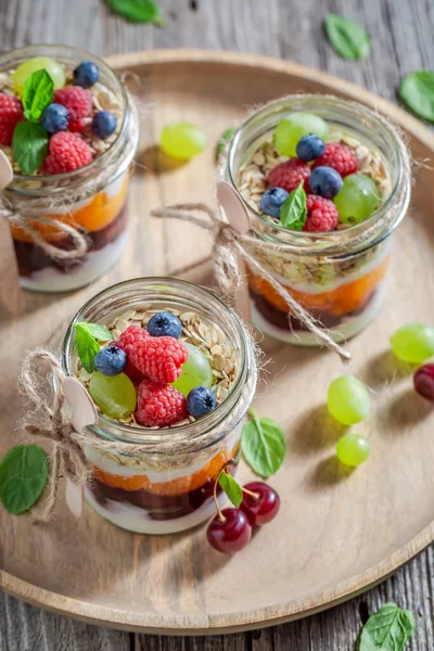 stock image Delicious and homemade granola made of yoghurt and flakes. Summer breakfast with fruits.