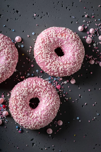 Homemade and sweet pink donuts for Fat Thursday festive. Donuts is most popular dessert.