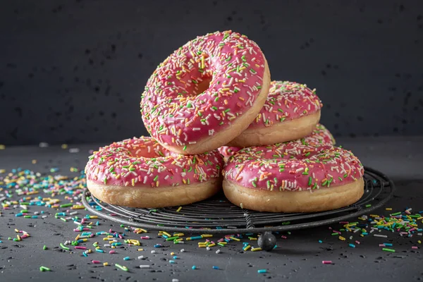 Tasty and colorful pink donuts for Fat Thursday festive. Donuts is most popular dessert.