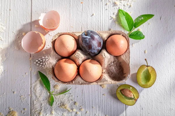 Preparation for sweet plum cake made of flour, eggs and fruits. Ingredients for homemade plum cake.