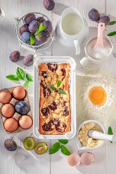 Ingredients for delicious plum cake with fruits and crumble. Ingredients for homemade plum cake.