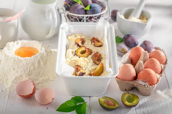 Ingredients for delicious plum cake made of flour, eggs and fruits. Ingredients for homemade plum cake.