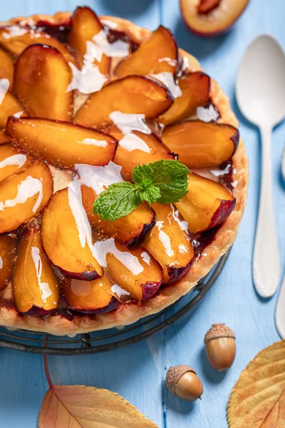 Delicious plum tart made of fruits and cream. Cake with plums and cream.
