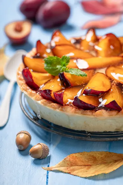 Tasty plum tart made of fruits and cream. Cake with plums and cream.