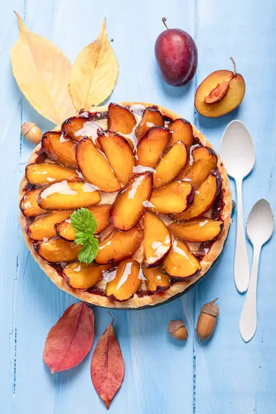 Delicious plum tart as an autumn cake for cold days. Cake with plums and cream.