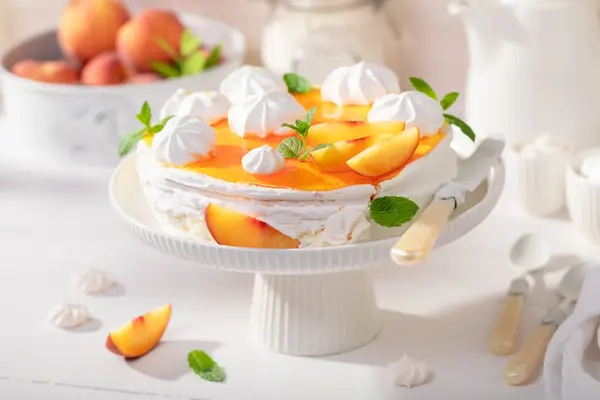 Homemade peach meringue with powdered sugar and fruits. Peach meringue with caster sugar and fruits.