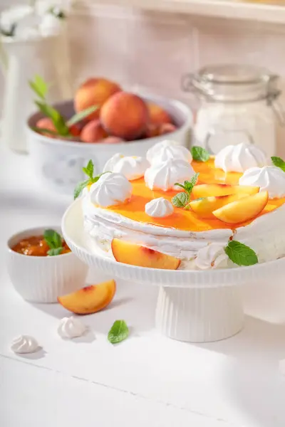Sweet peach meringue made of whipped cream and fruit. Peach meringue made of fruits and cream.
