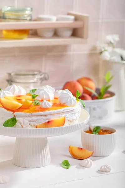 Sweet peach meringue made of fresh fruits. Peach meringue with caster sugar and fruits.