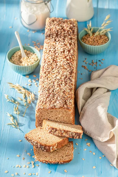 Homemade bran bread with seeds and ears of grains.. Wholegrain bread with bran.