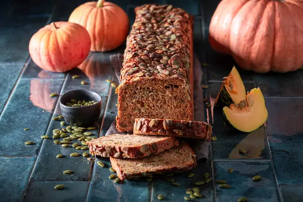 Golden pumpkin bread as holiday bread for Halloween. Freshly baked bread with pumpkin seeds.