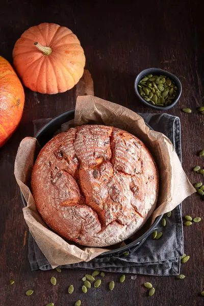 Healthy pumpkin bread with orange squashes and seeds. Freshly baked bread with pumpkin seeds.