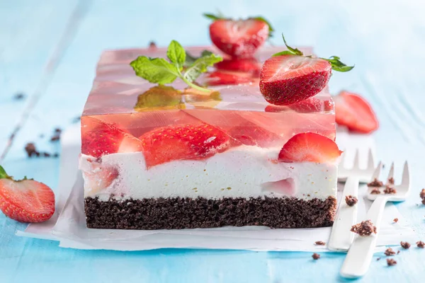 Delicious jelly cake with strawberries an airy sponge cake. Gelatin cake with fruits.