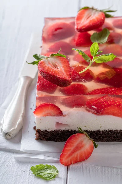 Tasty jelly cake with strawberries made of gluten free. Gelatin cake with fruits.