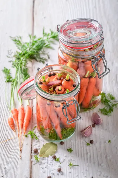 Homemade pickled carrots with vegetables from home garden.  Pickling carrots at home.