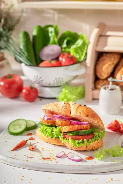 Spicy and delicious sandwich with chicken, cucumber and tomato Sandwich with chicken and vegetables.