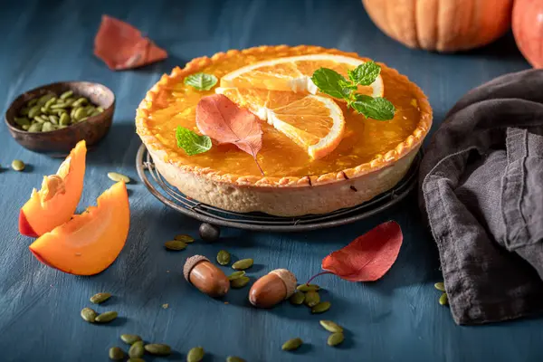 Sweet pumpkin tart made of autumn ingredients. Homemade cake in autumn.