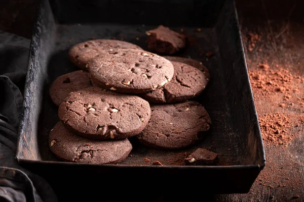 Crunchy and milky chocolate cookies made of cocoa and flour. Chocolate cookies with white chocolate chips.