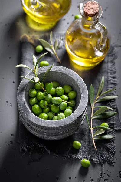 Green and ripe olives with raw olive berries. Green olives preparation for oil production.