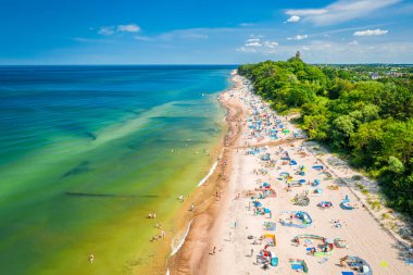 Flying above beach with people in Baltic Sea, Poland, aerial view clipart