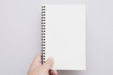 Elin boş bir defter ya da kitap tutuyor. Model kitap. Boş defter, boş kitap. Metin eklemek için kitapta boş alan.