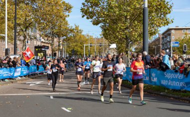 2022 Amsterdam Maratonu 'nun sonlarına doğru birden fazla koşucunun resmi..